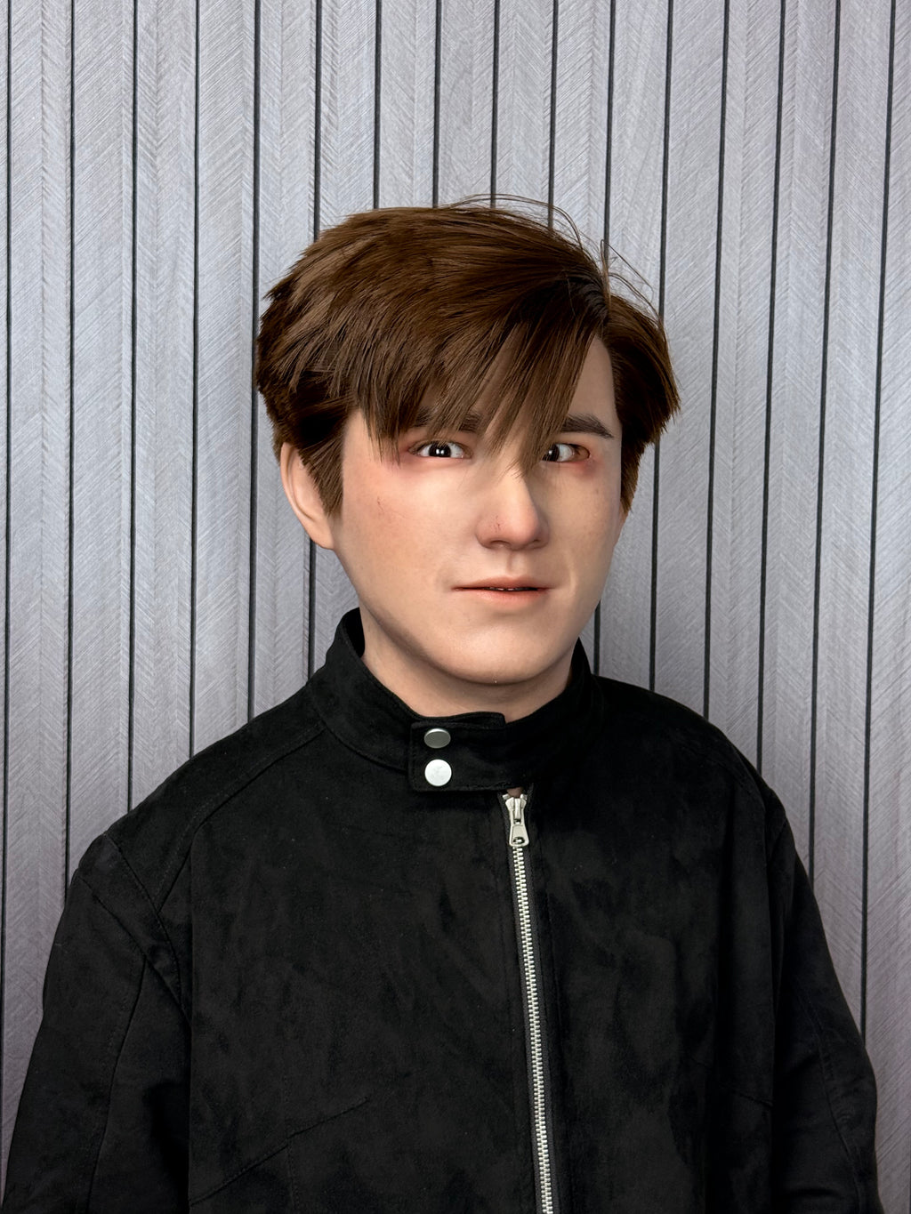 Young male silicone mask with realistic brown hairstyle